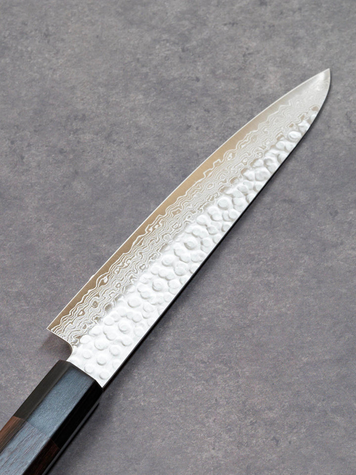 Back side of a 150mm Damascus petty knife with AUS-10 high-carbon steel blade and solid wood handle, crafted by Fujikan in Japan.