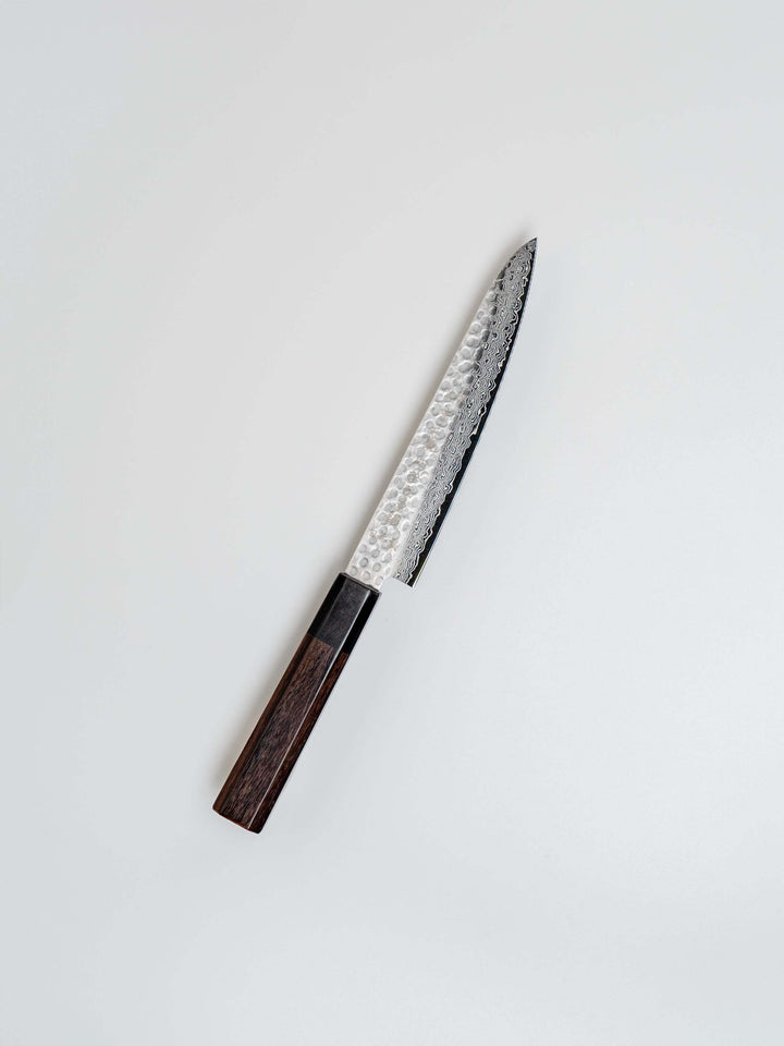 150mm Damascus petty knife with AUS-10 high-carbon steel blade and solid wood handle, crafted by Fujikan in Japan.