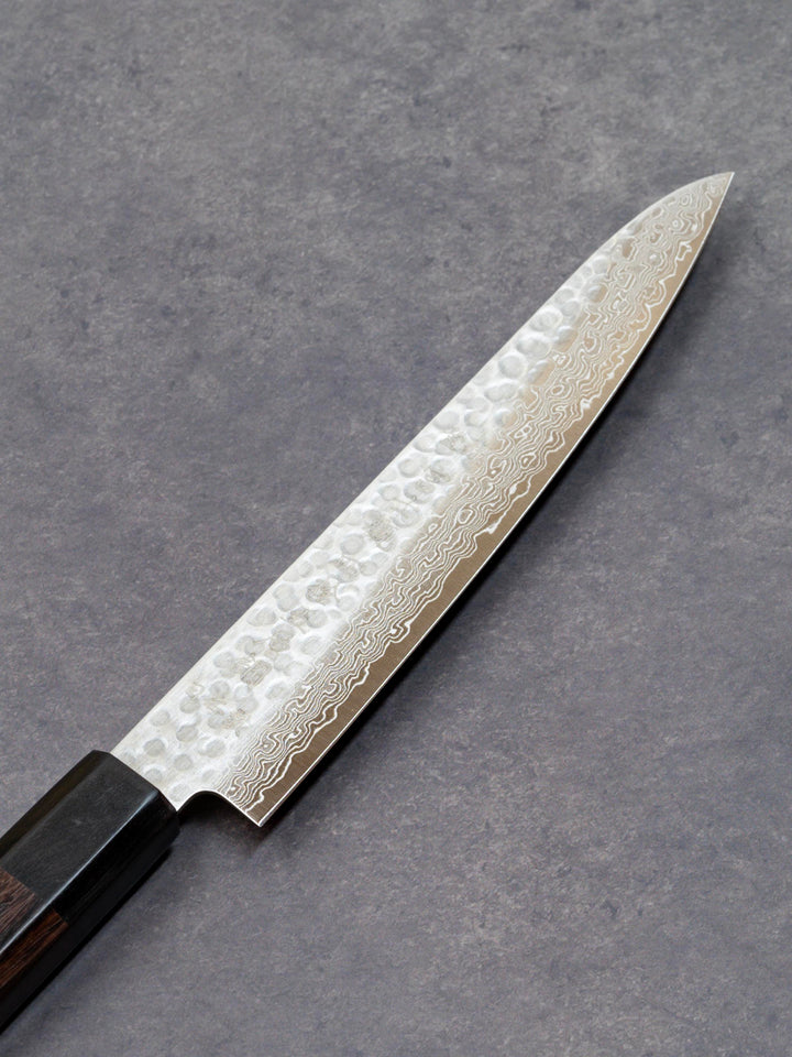 Front side of a 150mm Damascus petty knife with AUS-10 high-carbon steel blade and solid wood handle, crafted by Fujikan in Japan.