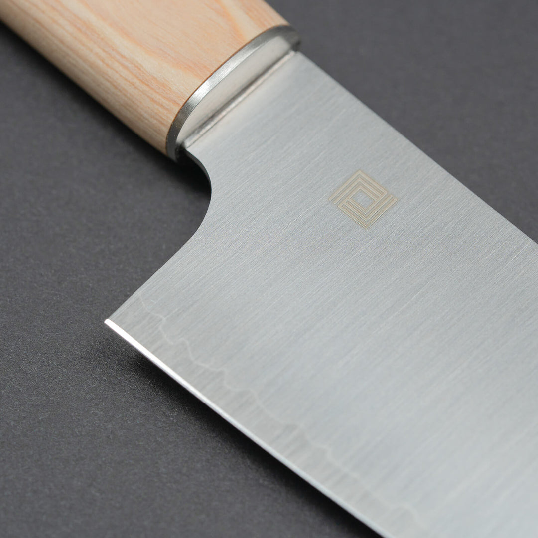 Close-up of 3-layer high-carbon steel blade with logo
